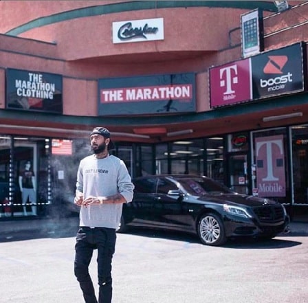 Nipsey Hussle in front of his clothing store 'Marathon Clothing'.